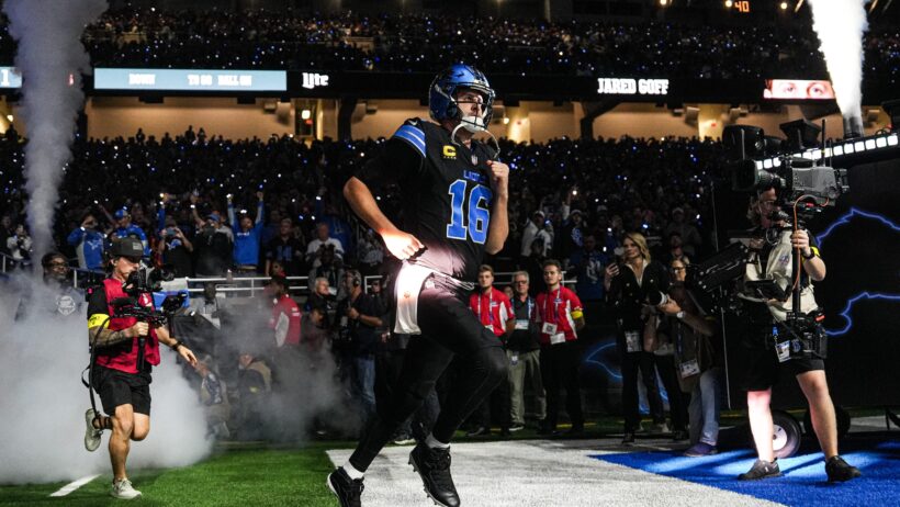 Detroit Lions quarterback Jared Goff running onto the field
