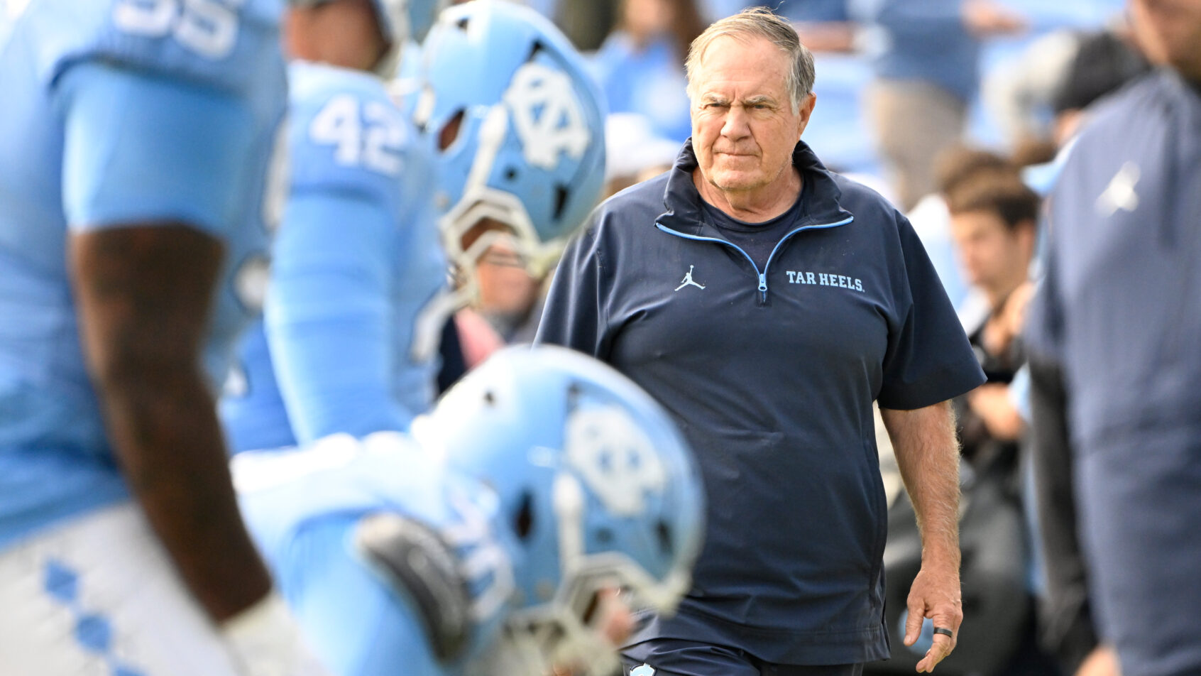 Bill Belichick looks on as his UNC Tar Heels warm up prior to a game.
