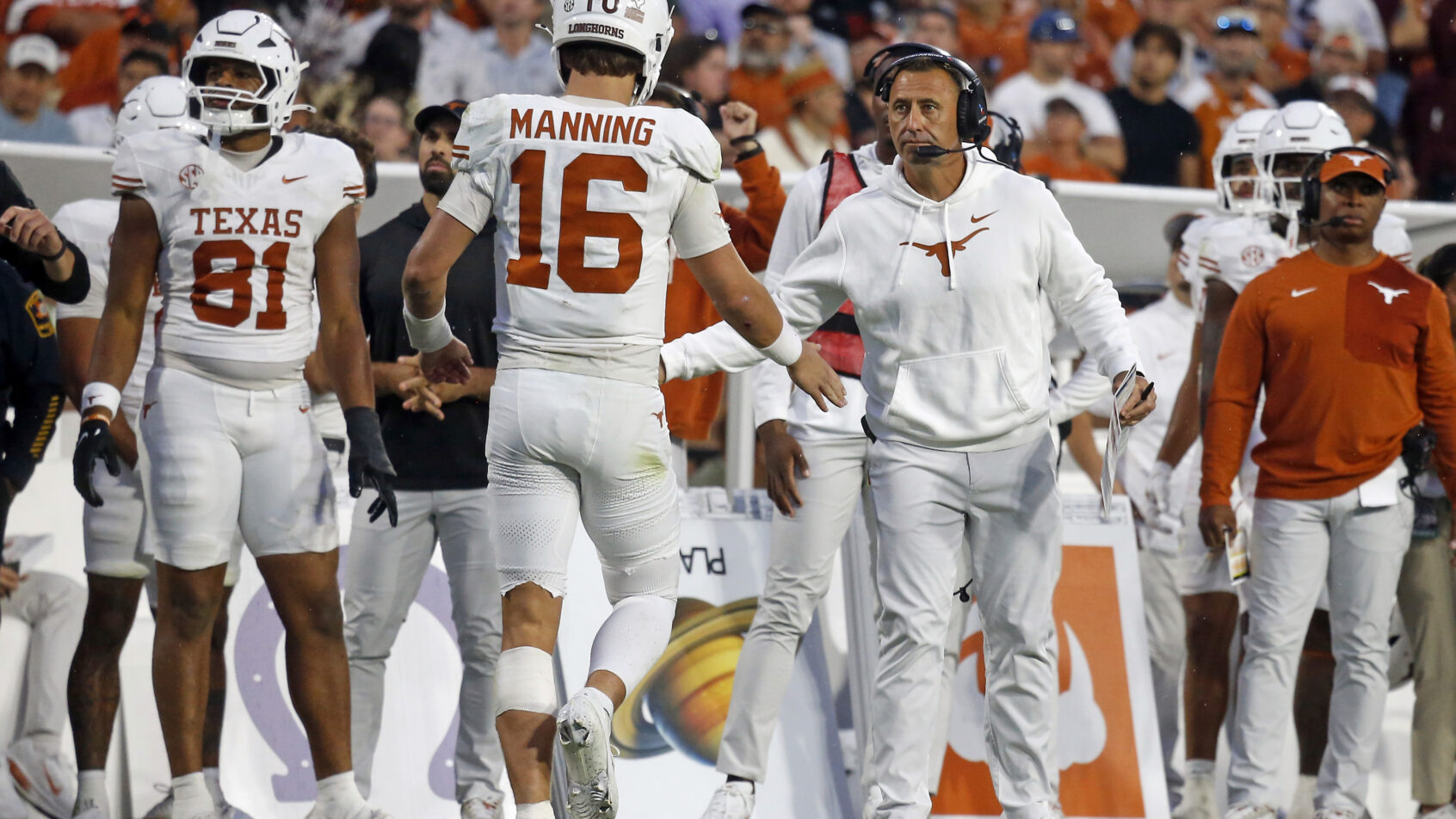 Arch Manning and Steve Sarkisian celebrate a win.