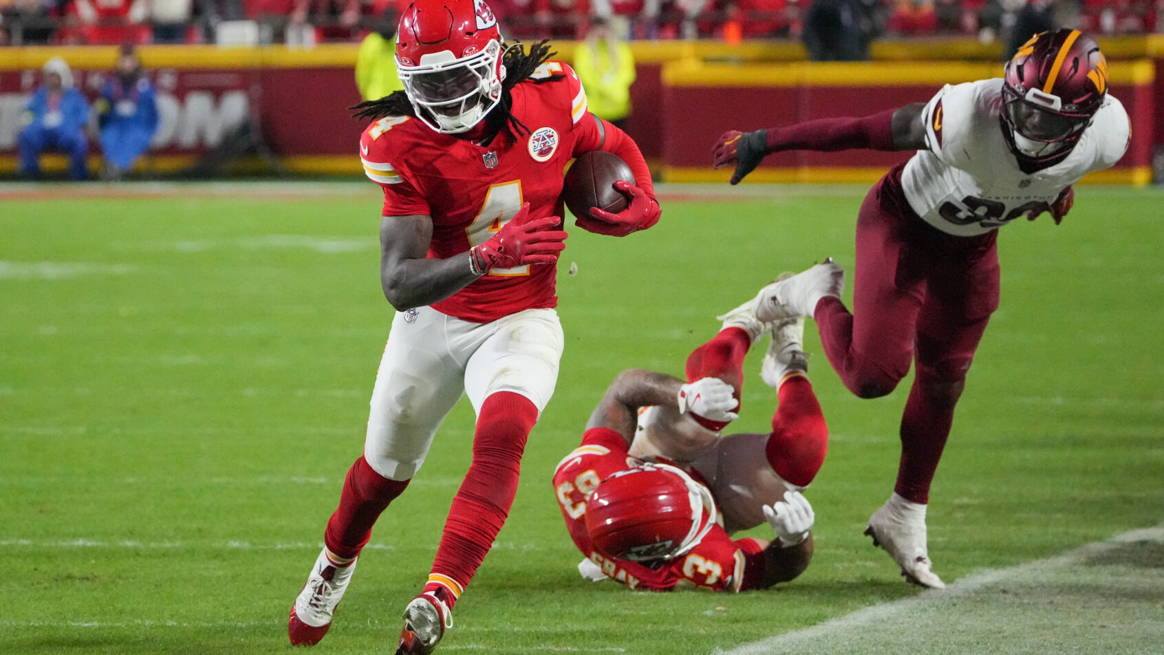 Rashee Rice running down the sideline with the ball