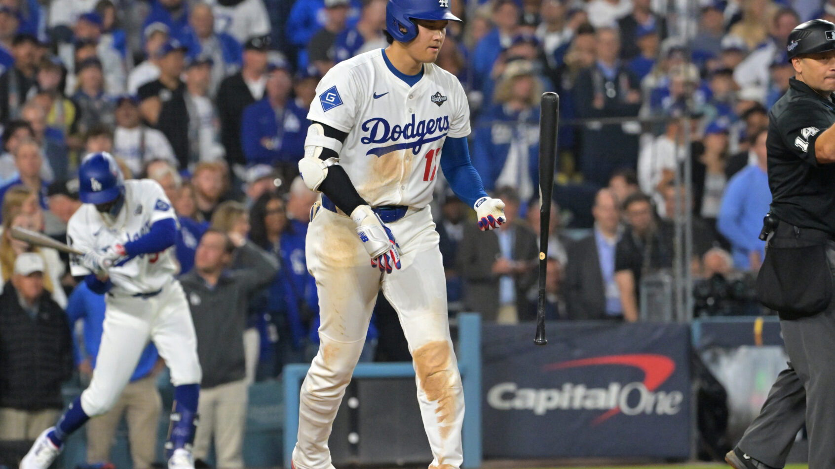 Los Angeles Dodgers two-way player Shohei Ohtani tosses his bat after a walk