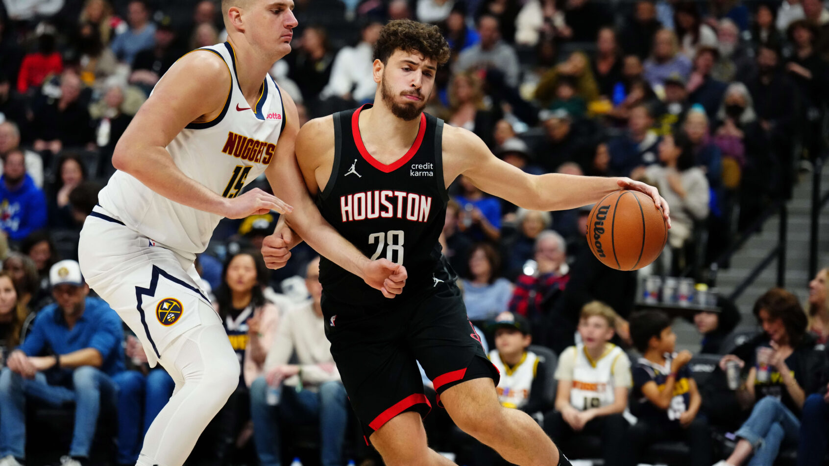 Houston Rockets center Alperen Sengun puts a shoulder into Denver Nuggets center Nikola Jokic