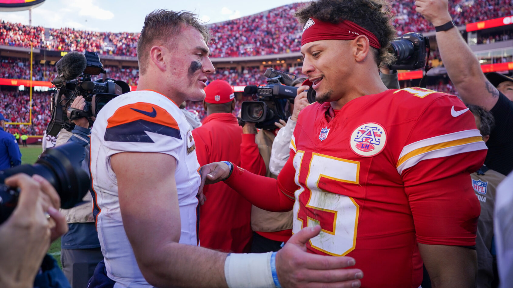 Denver Broncos quarterback Bo Nix and Kansas City Chiefs quarterback Patrick Mahomes shake hands after a game