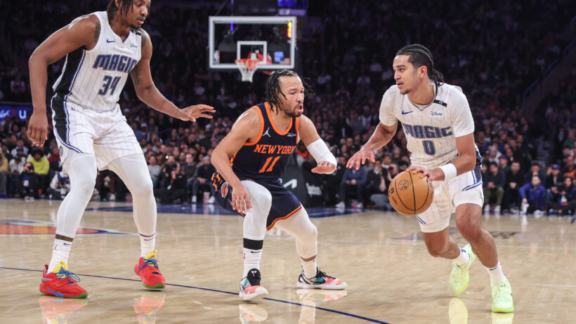 Orlando Magic guard Anthony Black dribbles as New York Knicks guard Jalen Brunson defends
