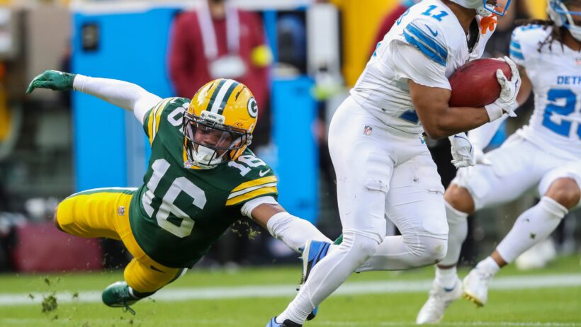 Detroit Lions wide receiver Kalif Raymond eludes a tackle by Green Bay Packers cornerback Bo Melton