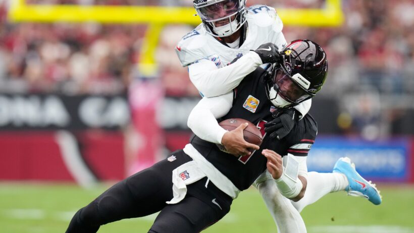 Arizona Cardinals quarterback Kyler Murray getting tackled from behind Tennessee Titans safety Amani Hooker