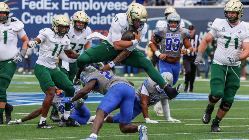 Byrum Brown leaps over a Memphis defender on his way into the end zone.