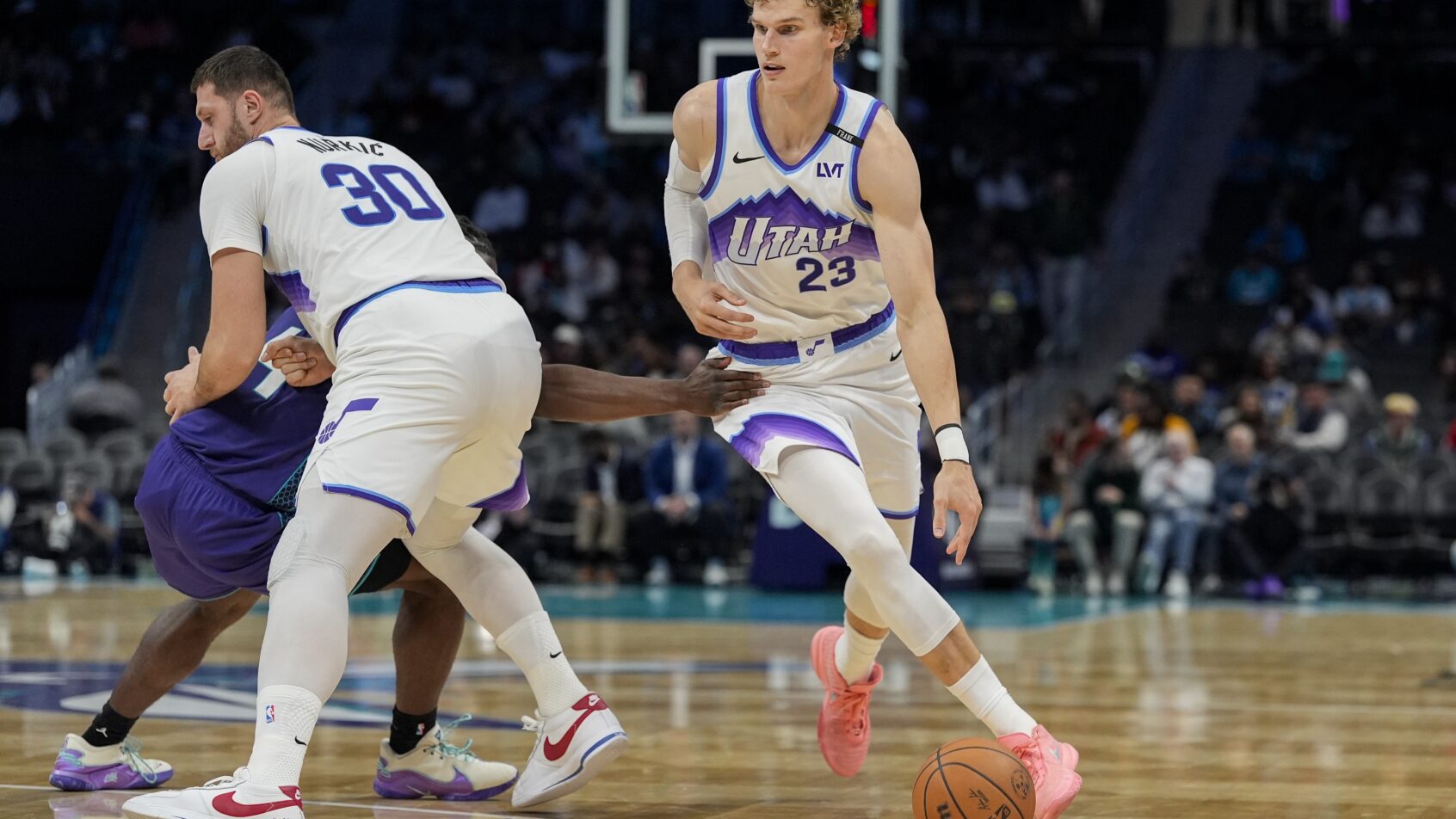 Utah Jazz forward Lauri Markkanen dribbles around a screen