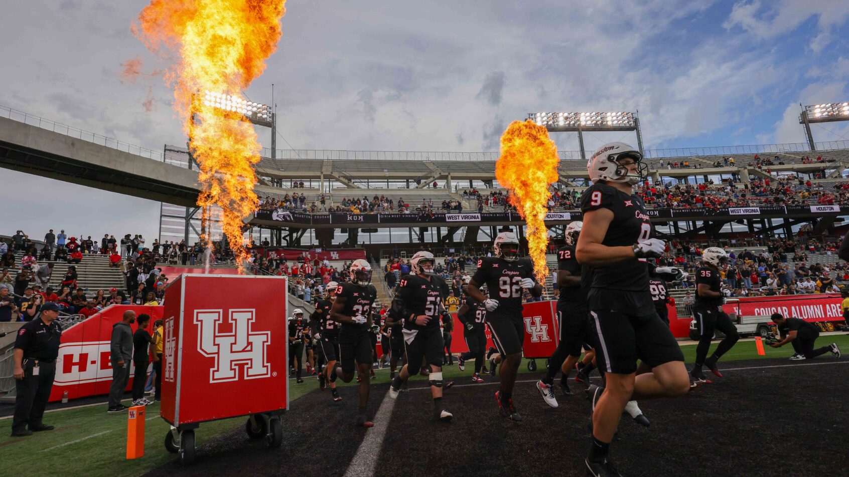 The Houston Cougars run onto the field versus West Virginia.