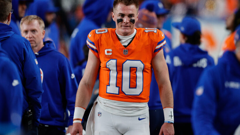 Bo Nix looks on from the sidelines in a game versus the Raiders.