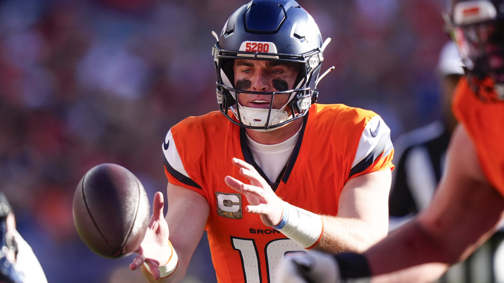 Denver Broncos quarterback Bo Nix receiving a snap