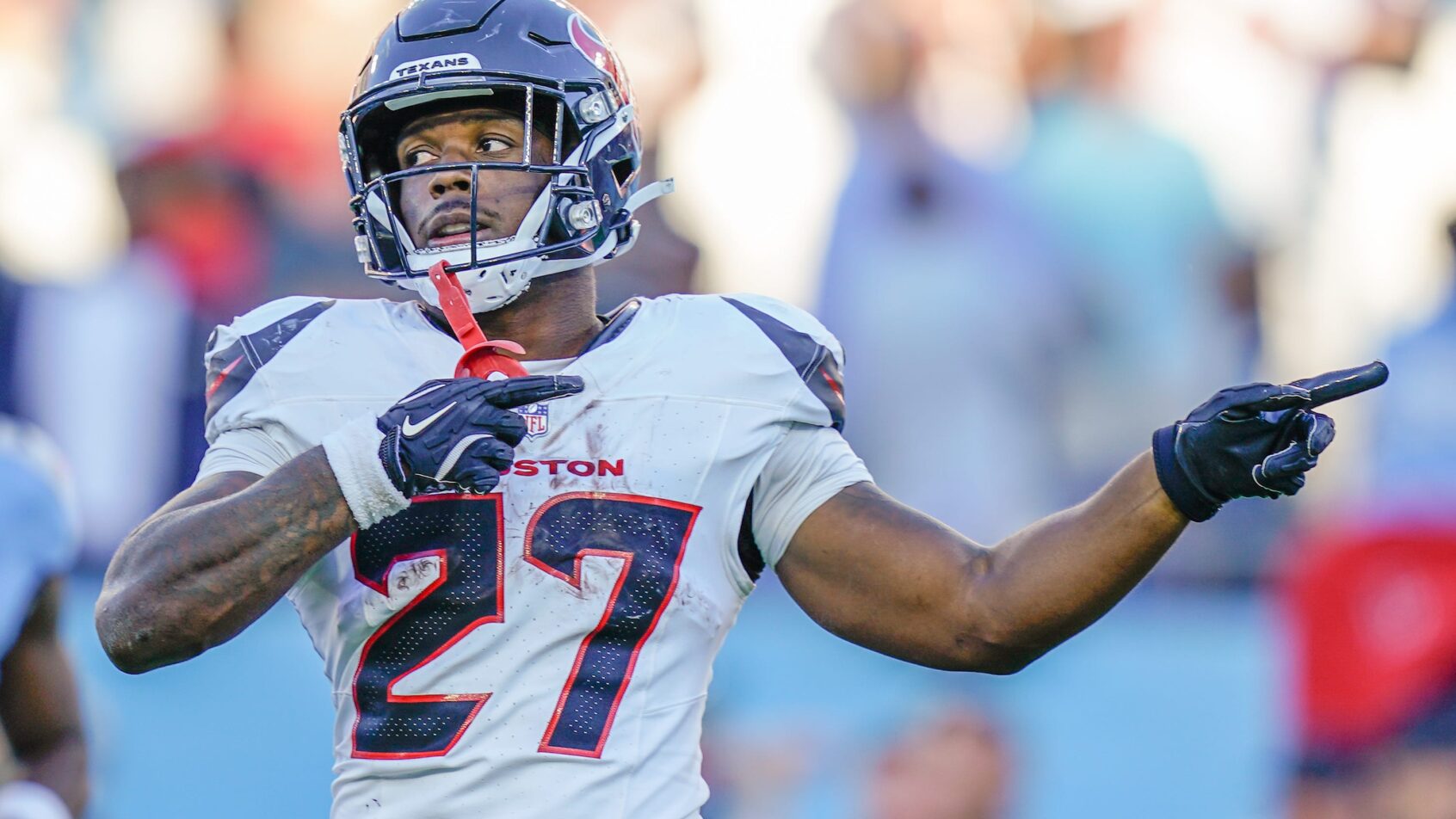 Woody Marks signals for a first down in a game versus the Titans.