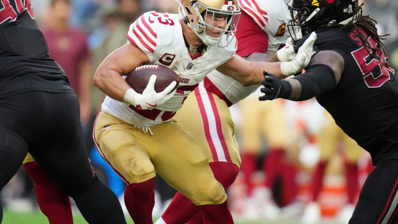 San Francisco 49ers Christian McCaffrey stiff-arms a would-be tackler
