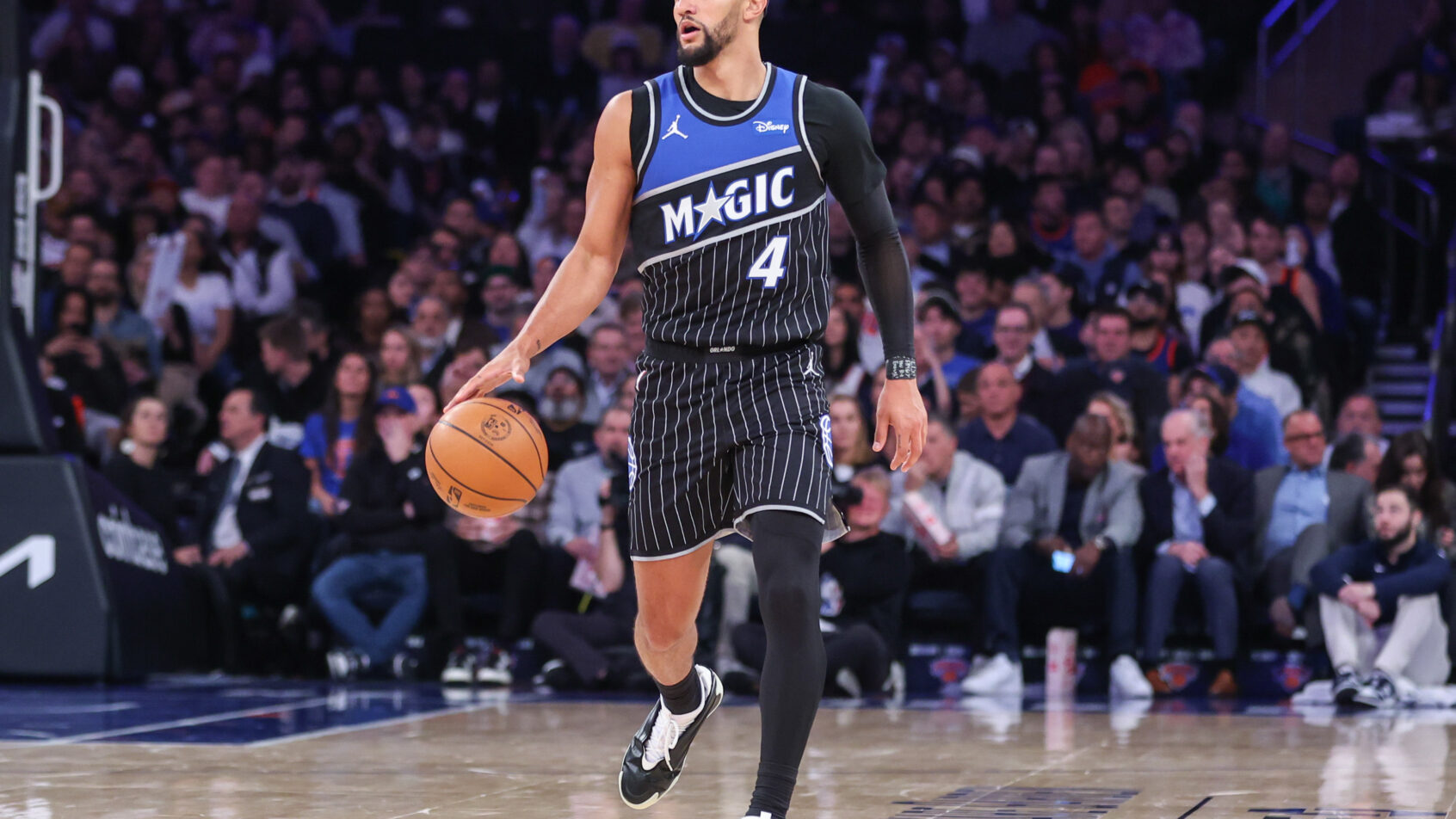 Orlando Magic guard Jalen Suggs walks the ball up the court