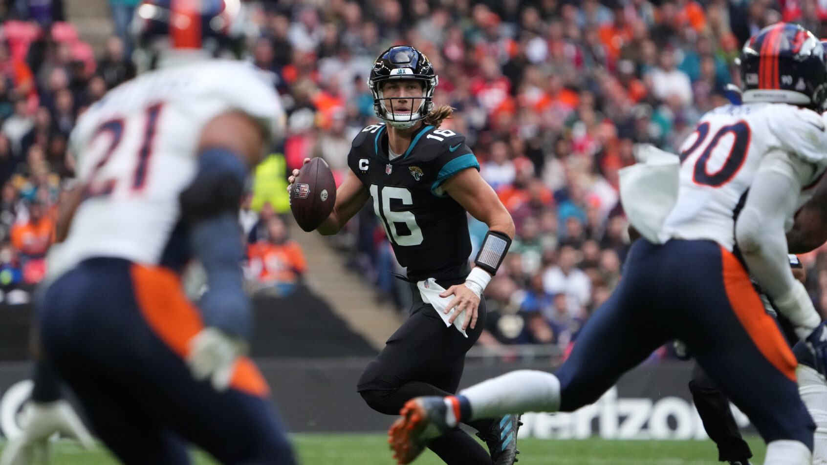 Jacksonville Jaguars quarterback Trevor Lawrence rolling out of the pocket