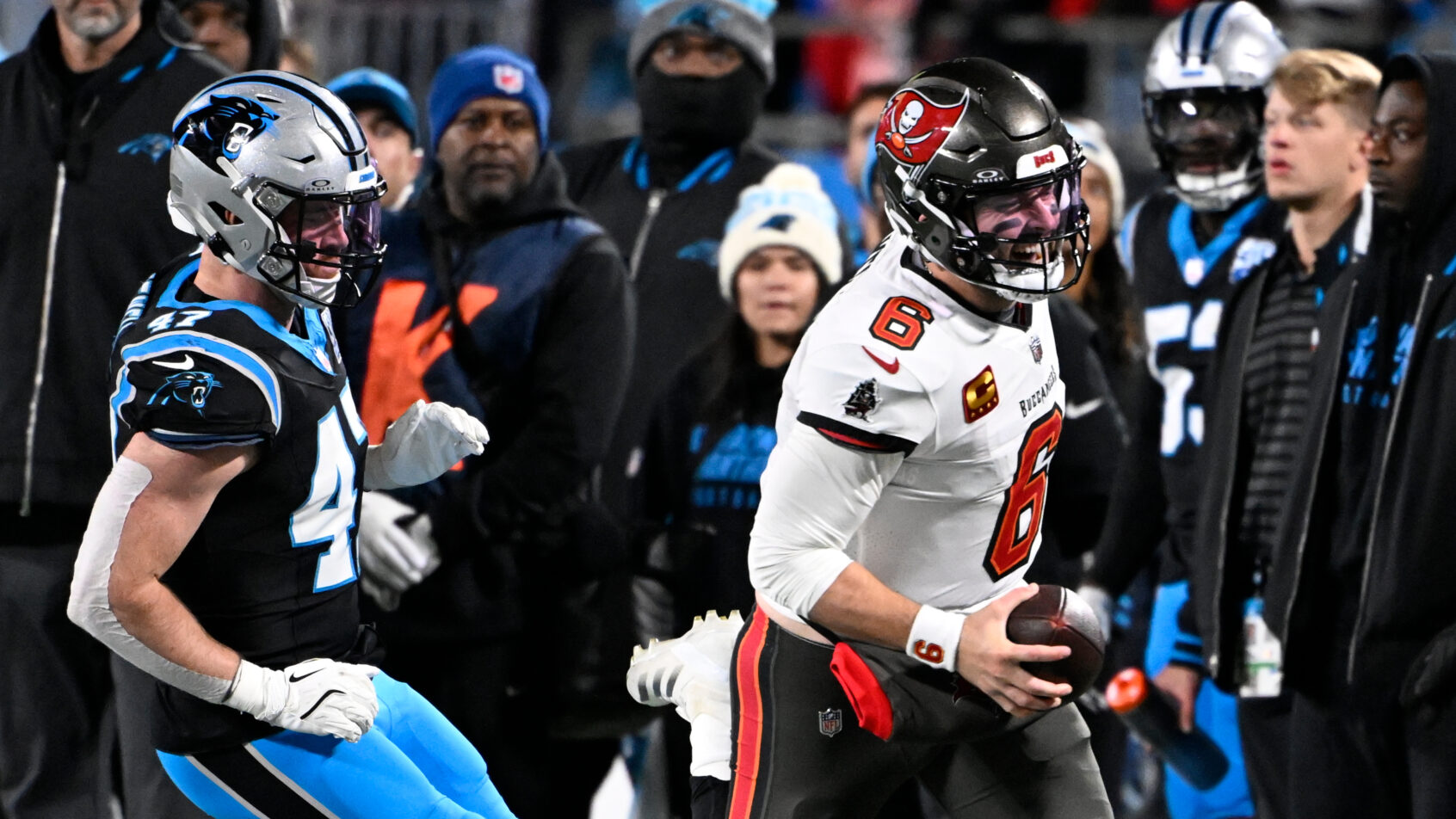 Tampa Bay Buccaneers quarterback Baker Mayfield runs with the ball as Carolina Panthers linebacker Josey Jewell pursues