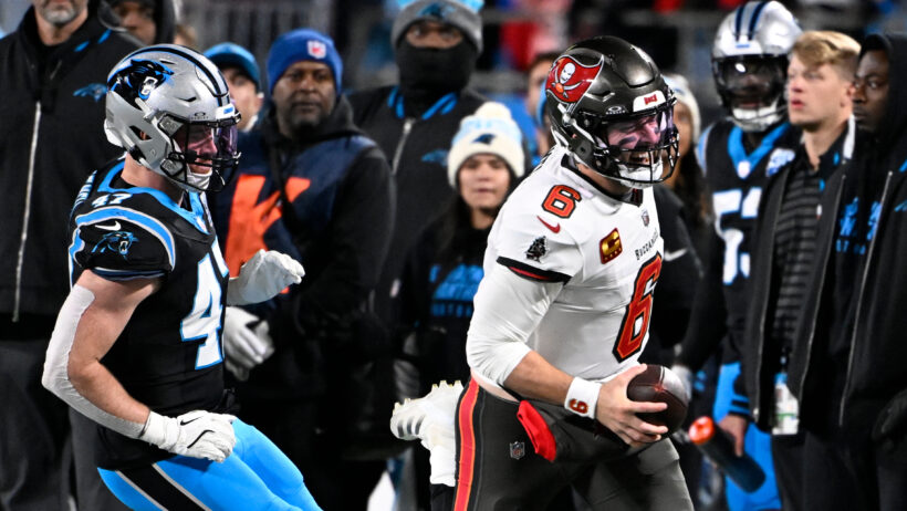 Tampa Bay Buccaneers quarterback Baker Mayfield runs with the ball as Carolina Panthers linebacker Josey Jewell pursues