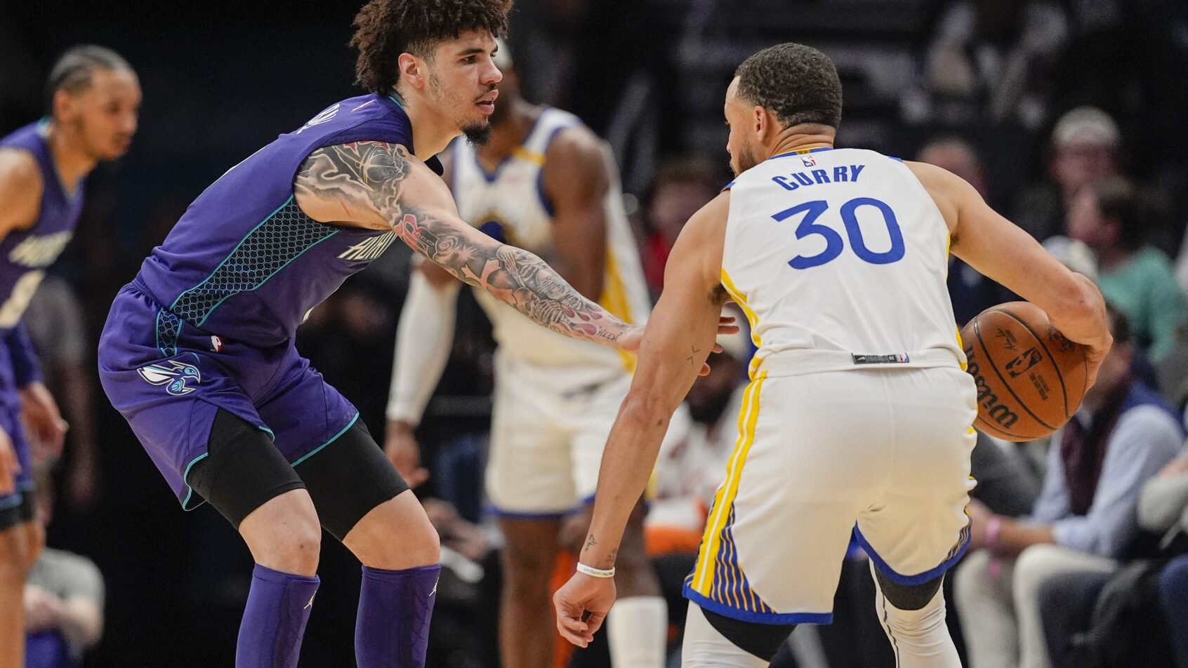 Charlotte Hornets guard LaMelo Ball guards Golden State Warriors guard Stephen Curry