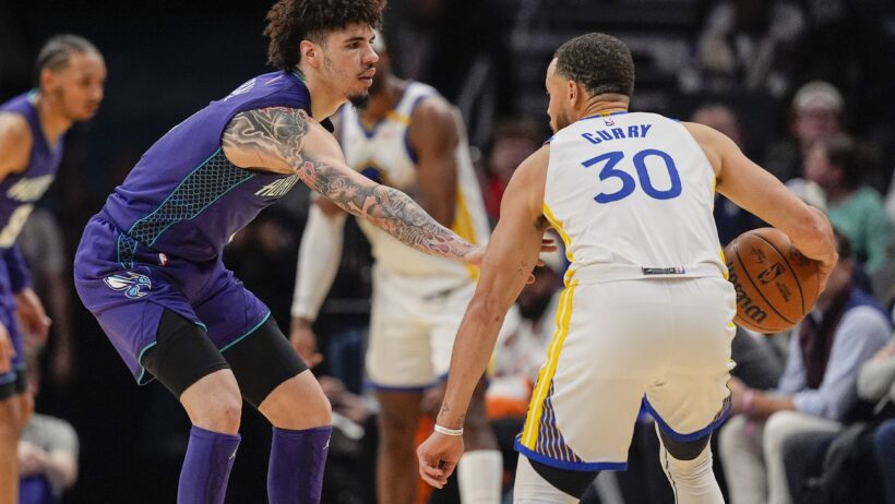 Charlotte Hornets guard LaMelo Ball guards Golden State Warriors guard Stephen Curry
