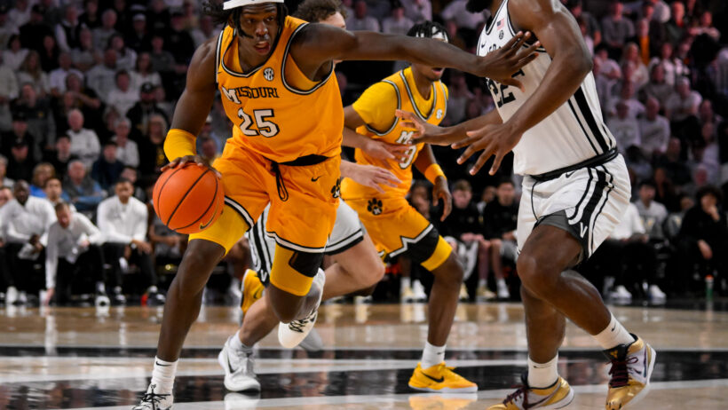 Missouri Tigers guard Mark Mitchell holds off a defender