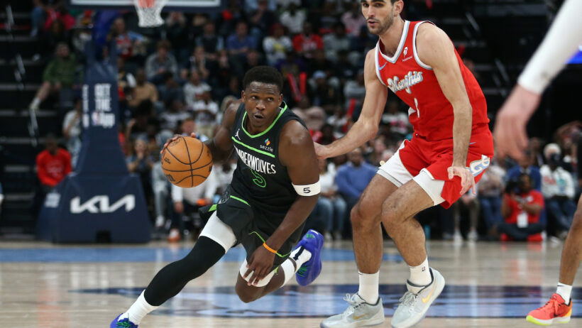 Minnesota Timberwolves guard Anthony Edwards drives around Memphis Grizzlies forward Santi Aldama