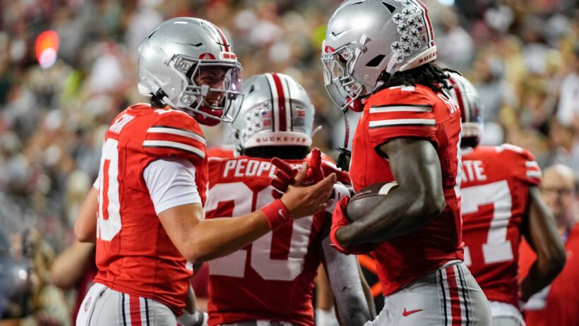 Ohio State Buckeyes quarterback Julian Sayin celebrates a touchdown by wide receiver Jeremiah Smith