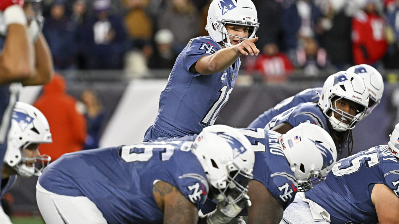 Drake Maye pointing at the line of scrimmage