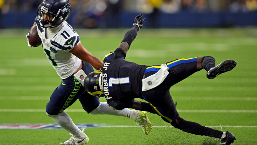 Seattle Seahawks wide receiver Jaxon Smith-Njigba eludes a tackle by Los Angeles Rams cornerback Emmanuel Forbes Jr