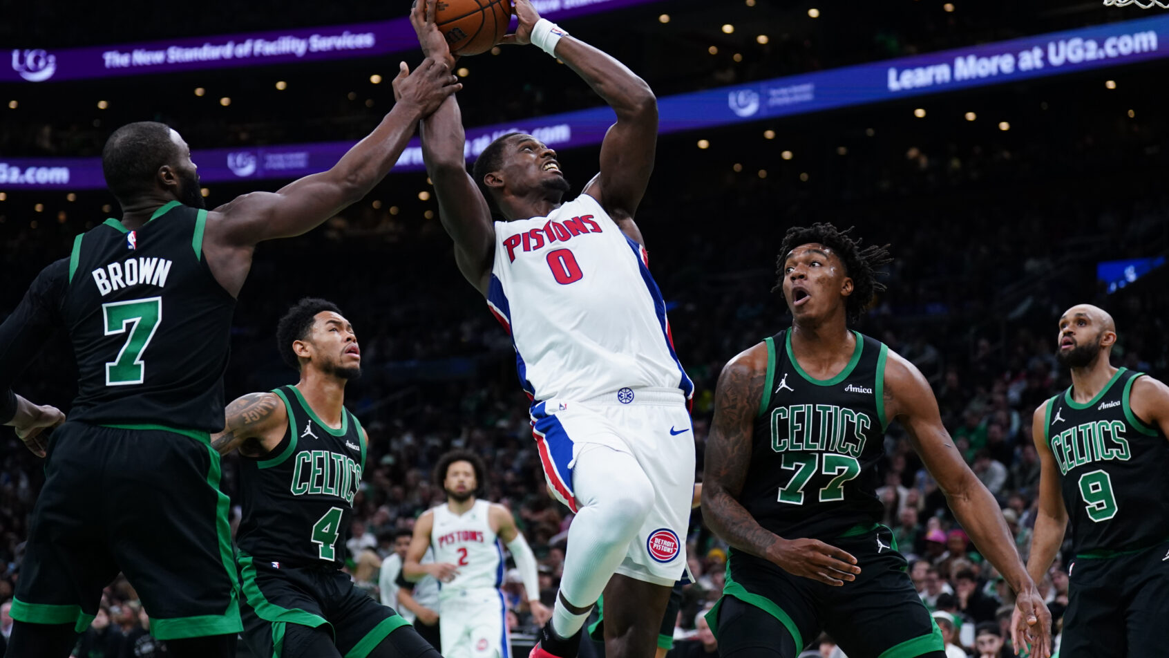 Detroit Pistons center Jalen Duren takes the ball to the basket against multiple Boston Celtics defenders