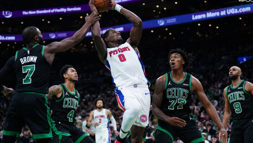 Detroit Pistons center Jalen Duren takes the ball to the basket against multiple Boston Celtics defenders