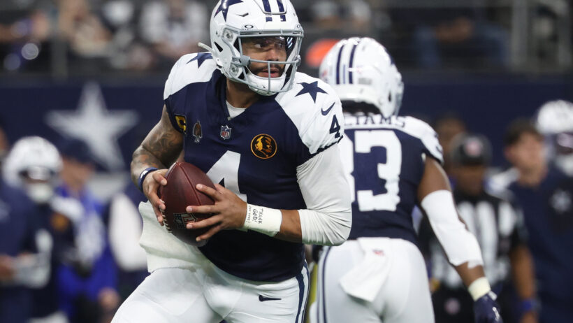 Dallas Cowboys quarterback Dak Prescott rolling out of the pocket