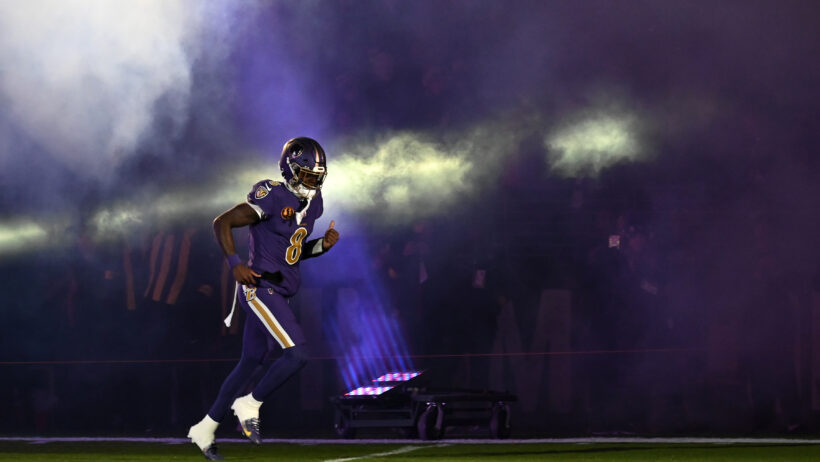 Lamar Jackson runs onto the field for a game versus the Bengals.