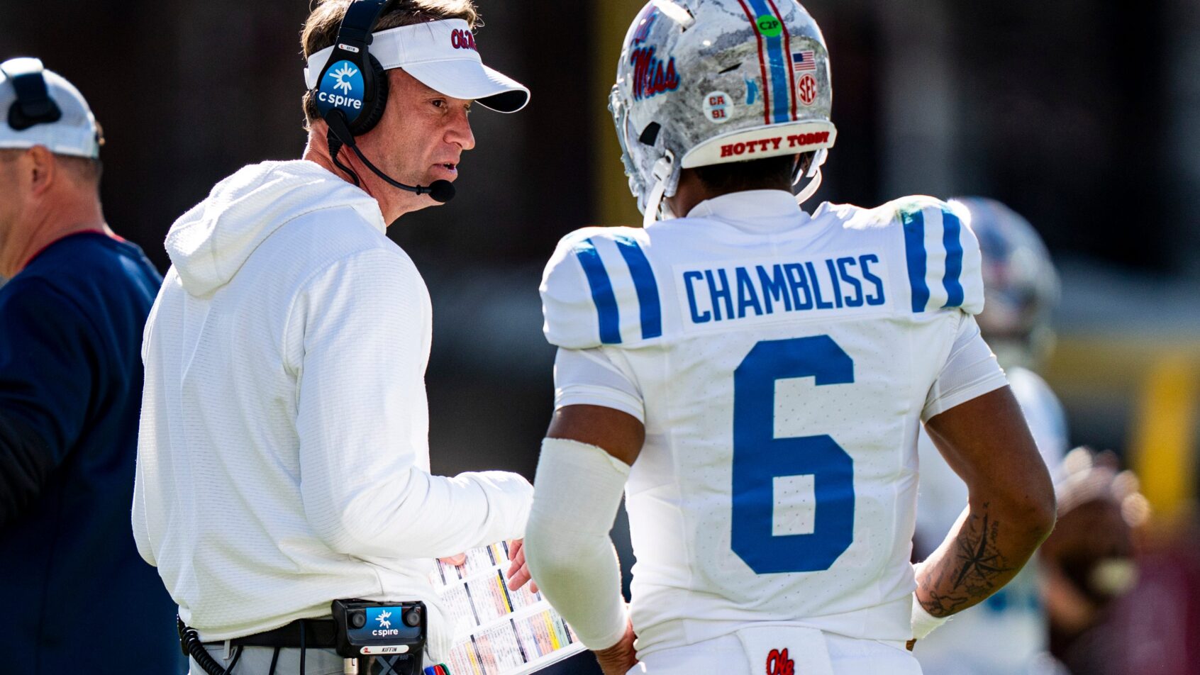 Ole Miss coach Lane Kiffin talking to quarterback Trinidad Chambliss on the sideline