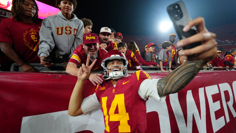 USC's Jayden Maiava poses for a selfie with a fan.