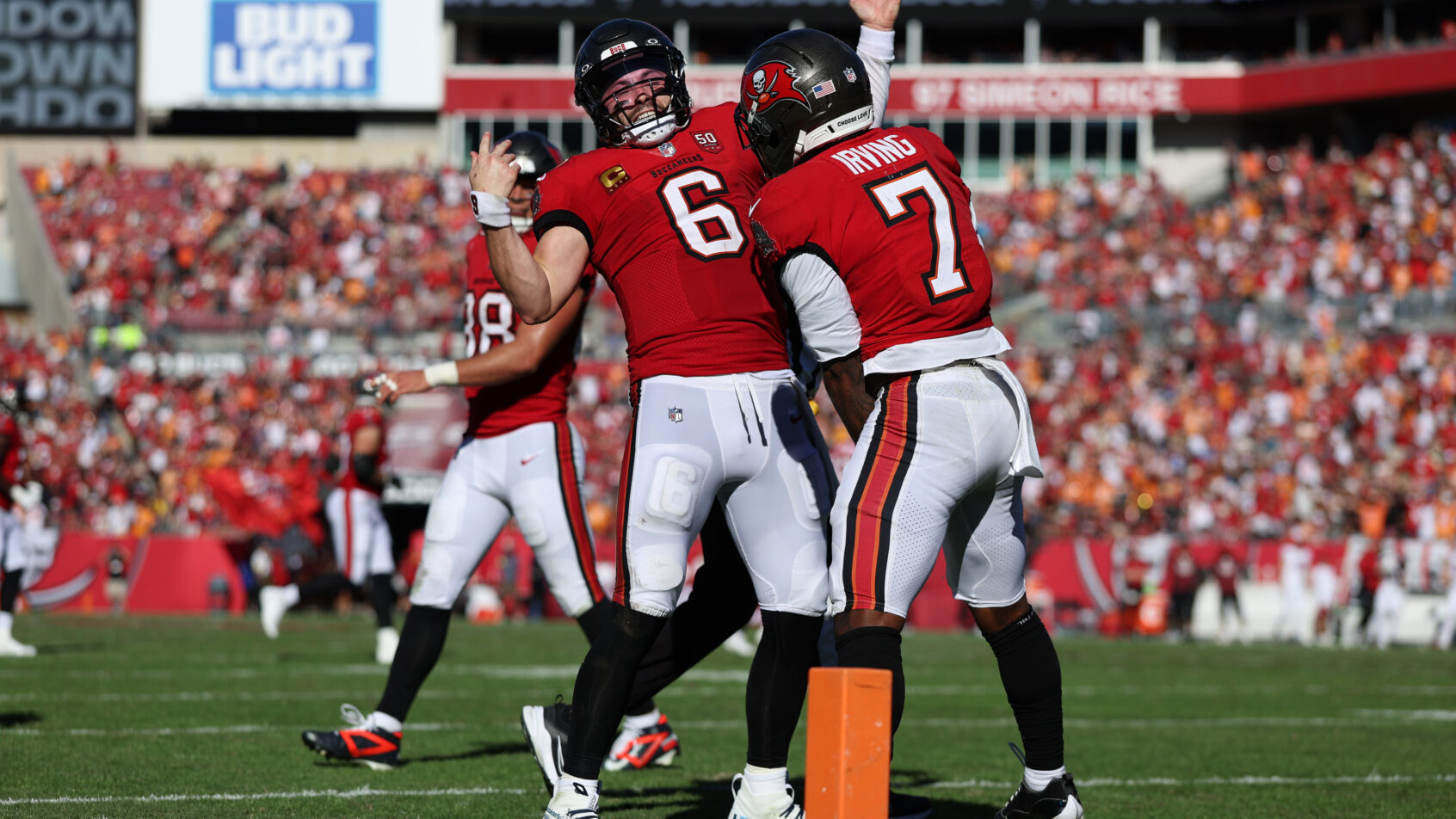 Bucky Irving celebrates a touchdown with Baker Mayfield.