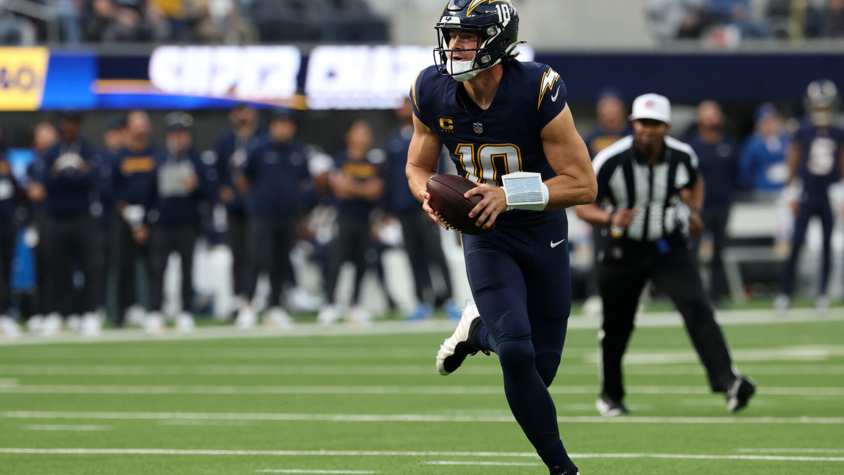 Los Angeles Chargers quarterback Justin Herbert scrambling out of the pocket