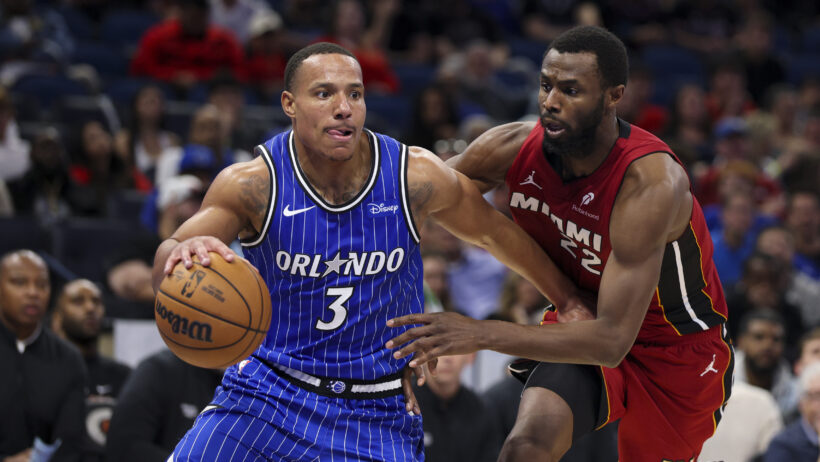 Orlando Magic guard Desmond Bane driving as Miami Heat forward Andrew Wiggins defends