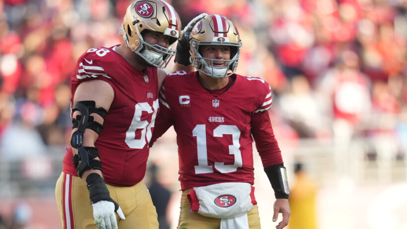 Brock Purdy celebrates a touchdown with one of his linemen.