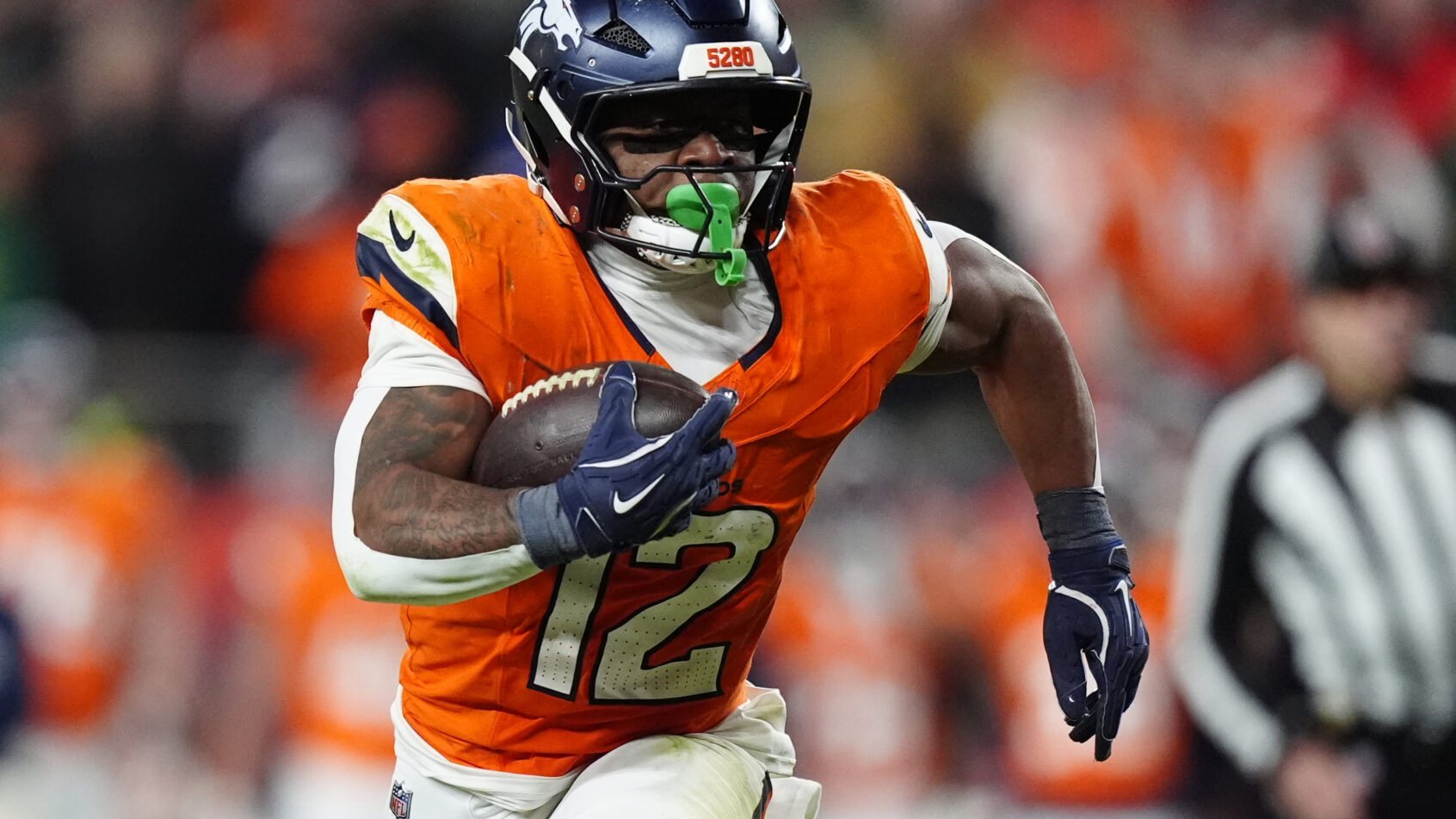 Broncos running back RJ Harvey rushing the ball against Green Bay.