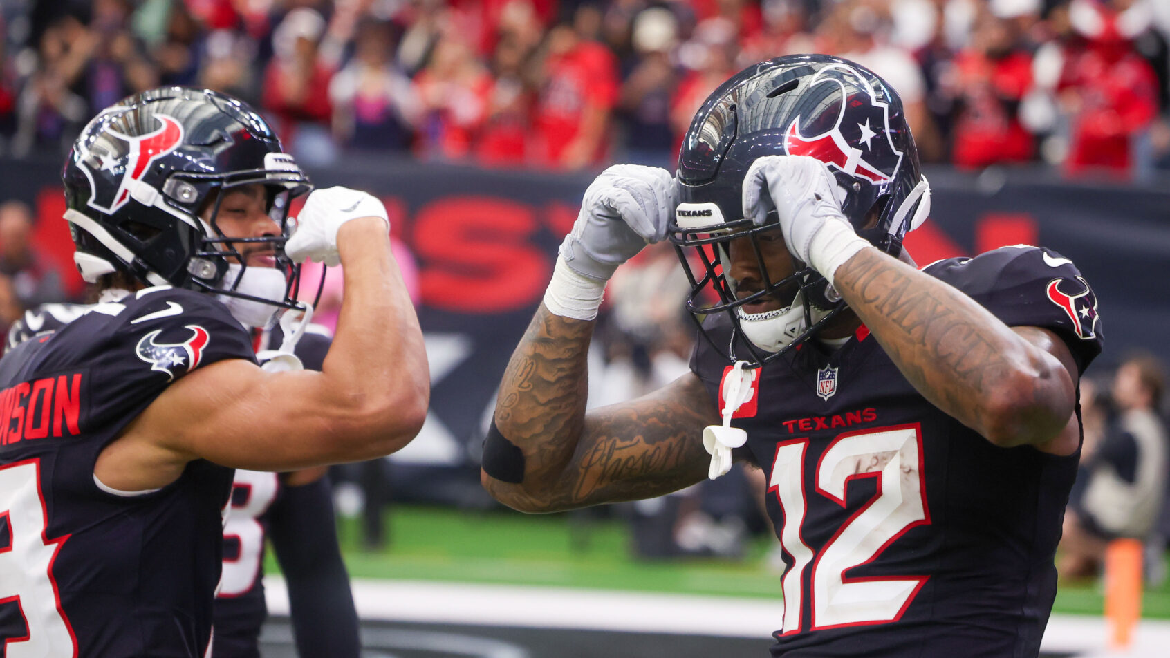 Nico Collins celebrating with a Texans teammate
