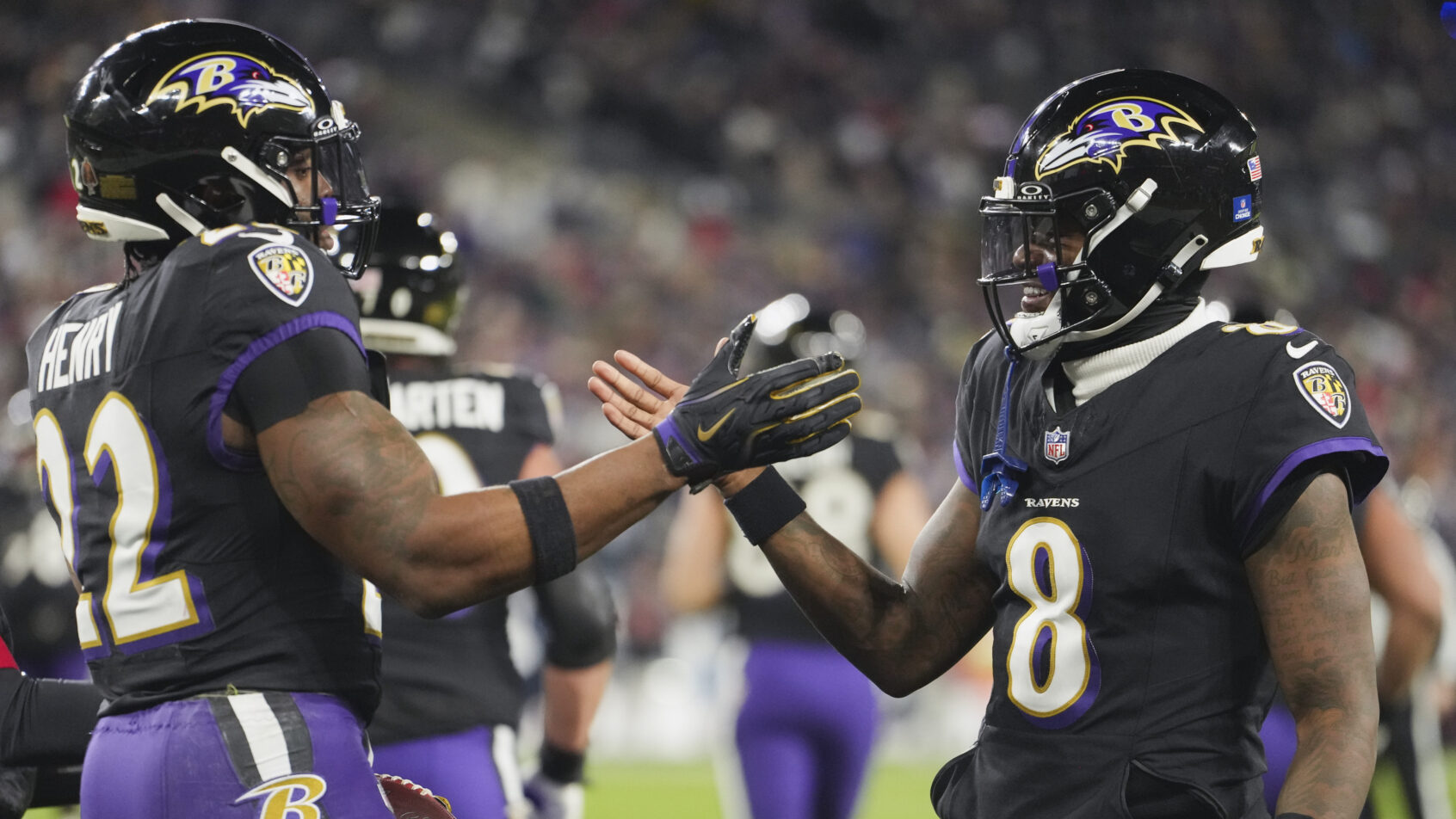 Baltimore Ravens quarterback Lamar Jackson and running back Derrick Henry celebrating