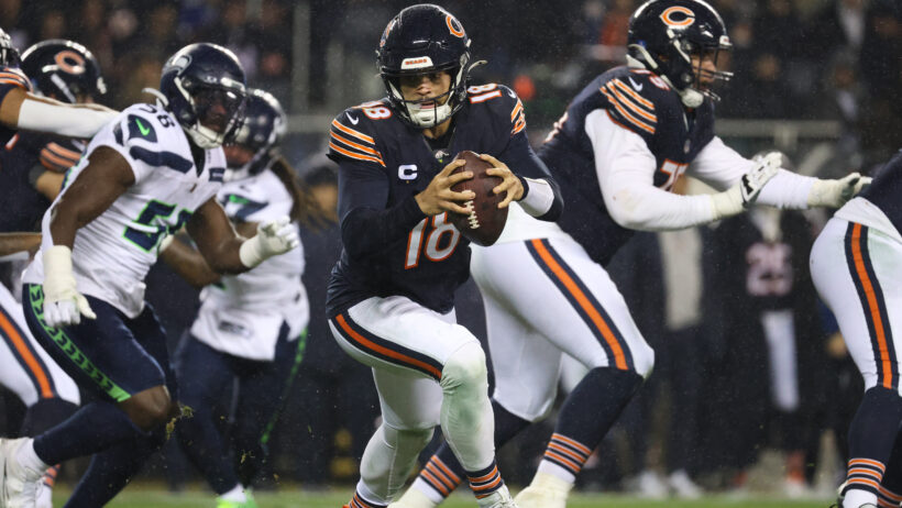 Chicago Bears quarterback Caleb Williams rolling out of the pocket