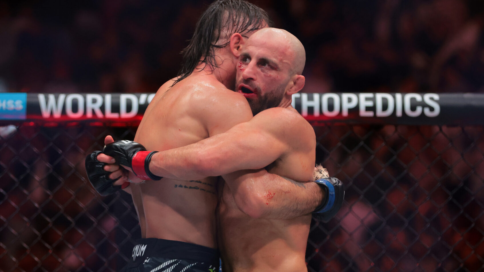 Alexander Volkanovsky and Diego Lopes hug after their UFC 314 bout.