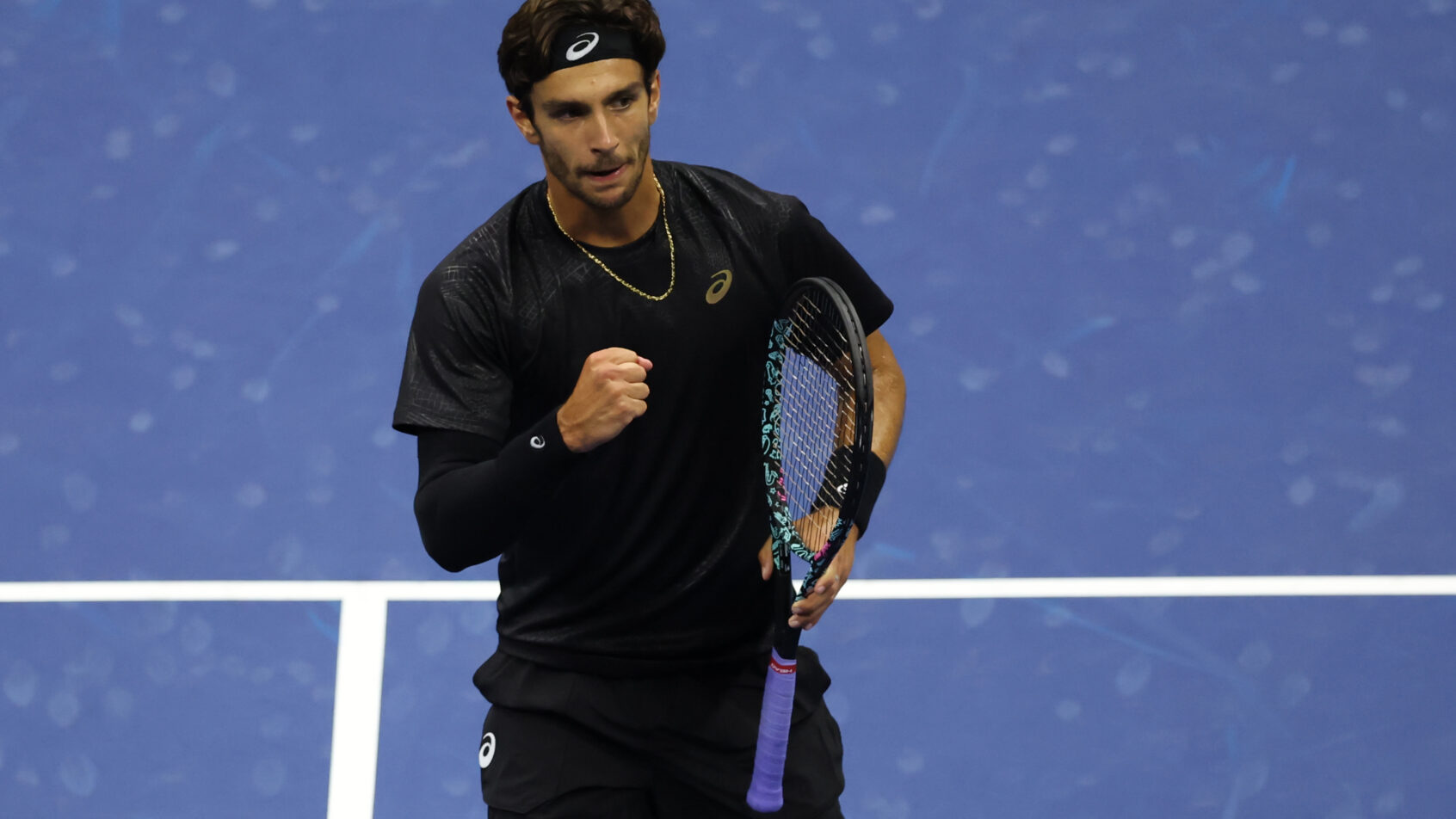 Lorenzo Musetti celebrates a point versus Jannik Sinner.