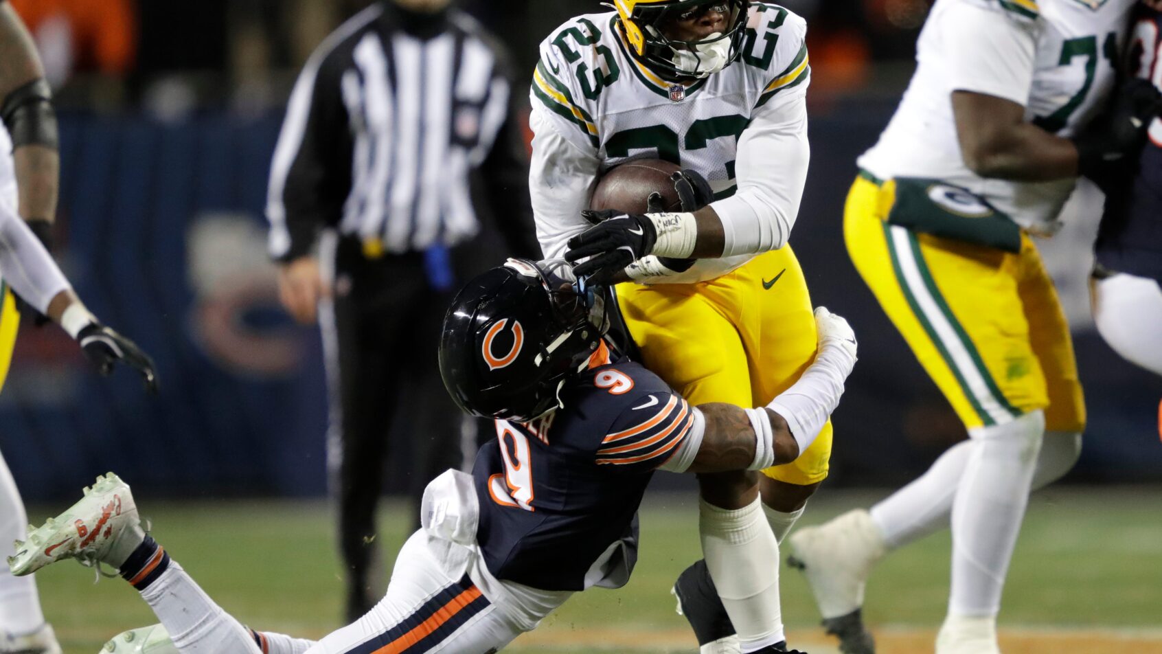 Chicago Bears safety Jaquan Brisker tackles Green Bay Packers running back Emanuel Wilson