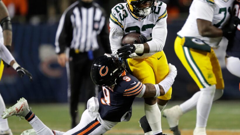 Chicago Bears safety Jaquan Brisker tackles Green Bay Packers running back Emanuel Wilson