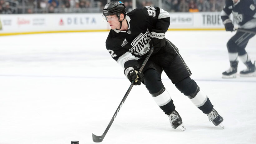 LA Kings defenseman Brandt Clarke (92) skates with the puck at home.