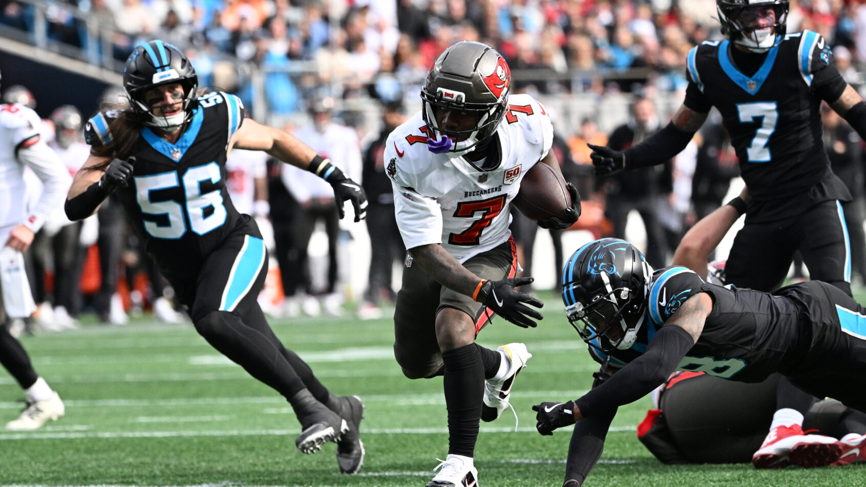 Bucky Irving breaks a tackle in a game versus Carolina.