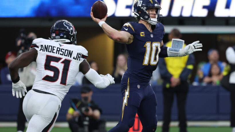 Justin Herbert throwing the football