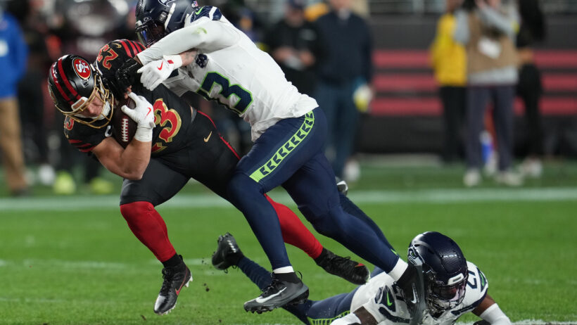 San Francisco 49ers running back Christian McCaffrey getting tackled by Seattle Seahawks cornerback Tyler Hall